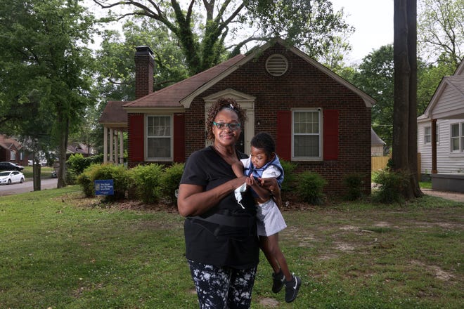 Dorothy Moore and her grandson Christopher Armstead Jr., 3, who was born with hydrocephalus, stand outside their Orange Mound home on Monday, May 2, 2022. Moore is in the process of having lead reduction work done in her home by the city of Memphis.