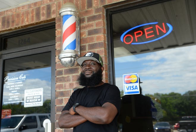Ja Morant of the NBA's Memphis Grizzlies went to Crestwood High School and grew up near Sumter, S.C. He was the 2nd overall pick in the 2019 NBA Draft behind Zion Williamson. His father, Tee Morant worked at Precision Cuts Barber Shop in Sumter. On May 7, 2022 family and friends of Tee Morant and Ja Morant came to the barber shop. As normal, many came to get a haircut, most talked about what Ja Morant would do in the NBA playoffs for the Memphis Grizzlies. Here, Jesse Wilson, 47, proudly stands outside Precision Cuts wearing his Grizzlies hat to support his friend Ja Morant.