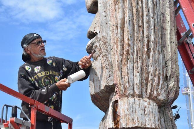 Artist Peter Wolf Toth works on his Whispering Giant sculpture at the Inlet on May 23 in Ocean City, Md.
