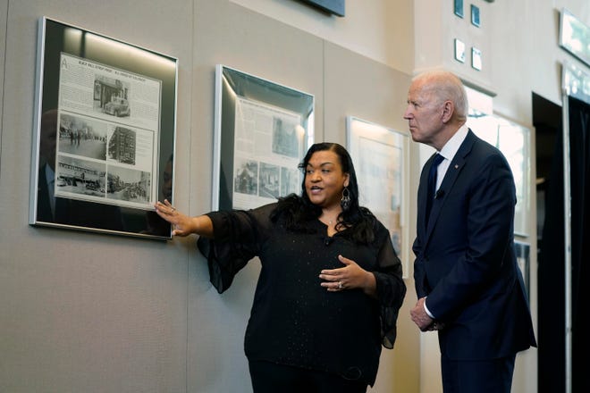 President Joe Biden listens to program coordinator Michelle Brown-Burdex during a tour of the Greenwood Cultural Center to mark the 100th anniversary of the Tulsa race massacre June 1, 2021, in Tulsa, Okla.
