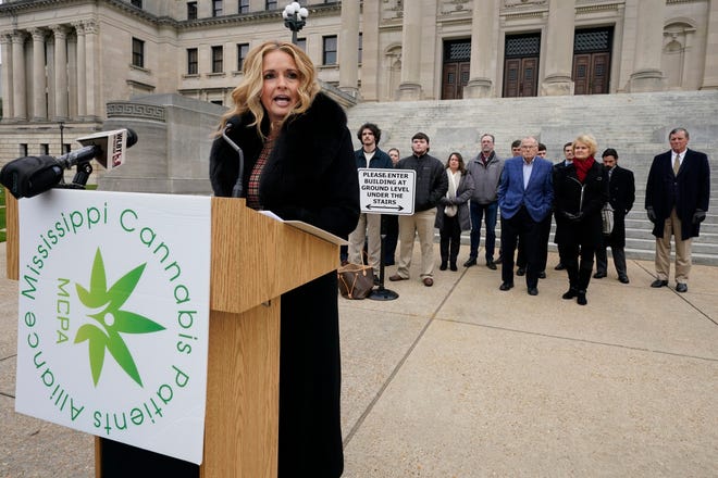 Angie Calhoun, CEO and founder of The Mississippi Cannabis Patients Alliance and a number of members, board members and advocates for medical marijuana, addresses reporters at the Mississippi State Capitol, in Jackson, to listen to their plea to the Legislature to pass the Mississippi Medical Cannabis Act "as is" on the first day of the new legislative session, Tuesday, Jan. 4, 2022.