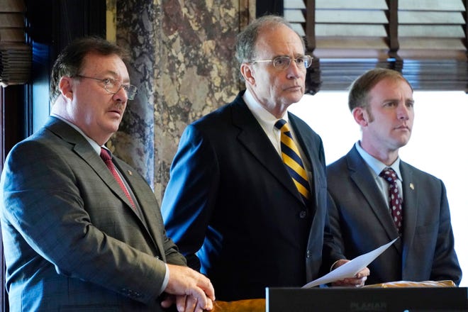 Lt. Gov. Delbert Hosemann, a Republican, center, stands with fellow Republicans, Senate Ports and Major Resources Committee Chairman Philip Moran of Kiln, left, and Senate Wildlife, Fisheries and Parks Committee Chairman Neil Whaley of Potts Camp, as they listen to action from the floor during the morning session of the Mississippi Legislature in Jackson, Thursday, Jan. 19, 2023.