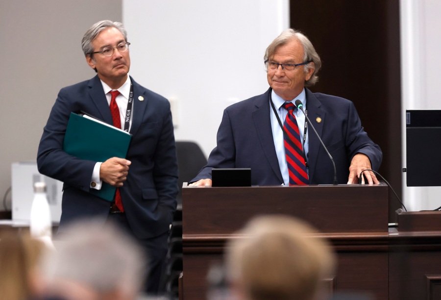 N.C. Sen. Bill Rabon shares his experience using marijuana illegally while undergoing chemotherapy to treat his cancer as Senate Bill 3, the NC Compassionate Care Act, is discussed during a House health committee meeting in Raleigh, N.C., Tuesday, May 30, 2023. Sen. Michael Lee stands to the left. (Ethan Hyman/The News & Observer via AP)